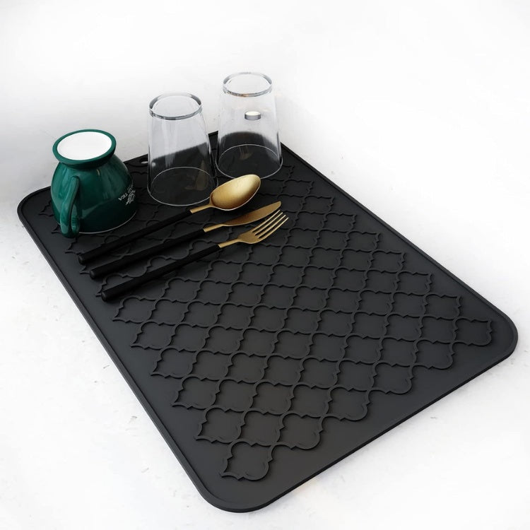 Black silicone dish drying mat on kitchen counter